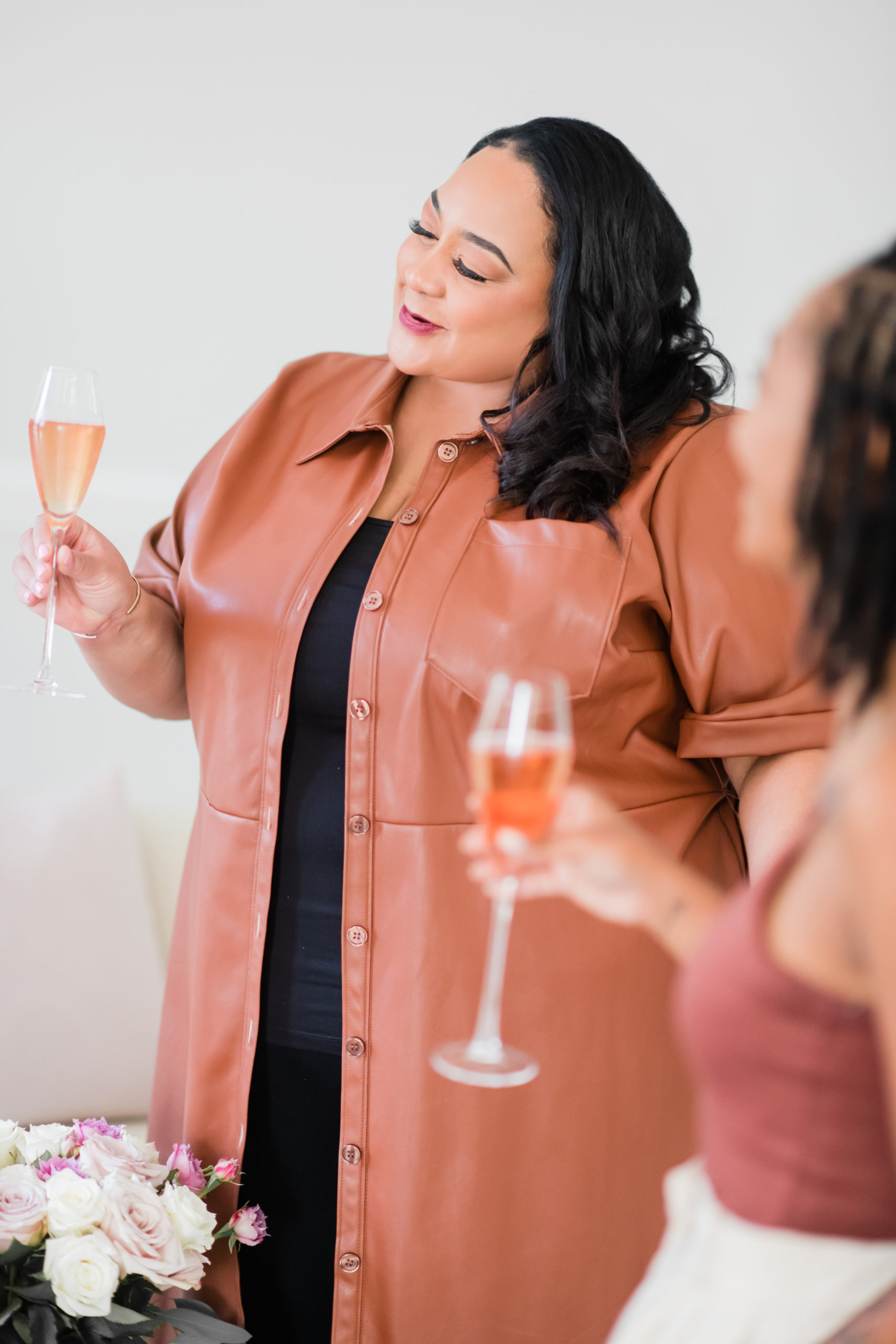 Black woman with champagne doing a toast.